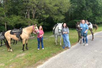 a group of girls posing with their horses at the stables at cedars of lebanon in nashville tn