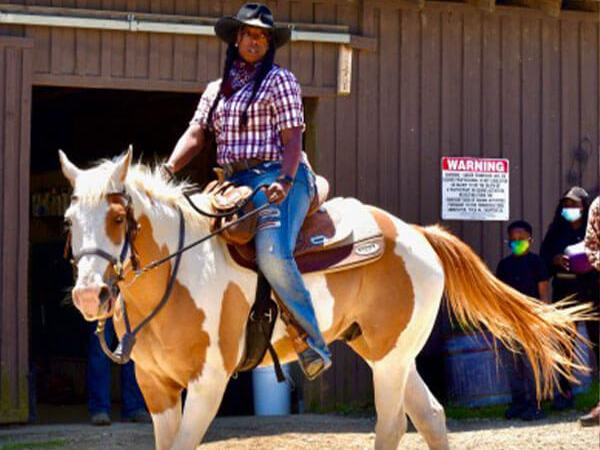a woman horseback riding at the stables at cedars of lebanon in nashville tn
