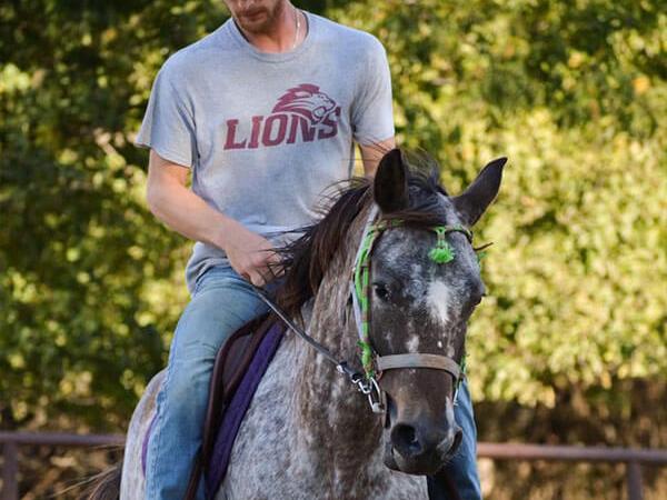 a man horseback riding at the stables at cedars of lebanon in nashville tn