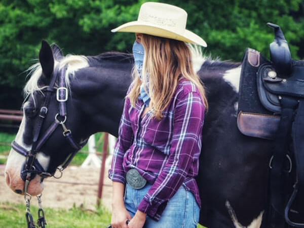 a woman posing with her horse at the stables at cedars of lebanon in nashville tn