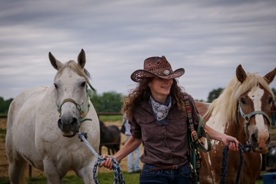 a person riding on the back of a brown horse